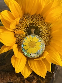 a yellow sunflower sits on top of a table